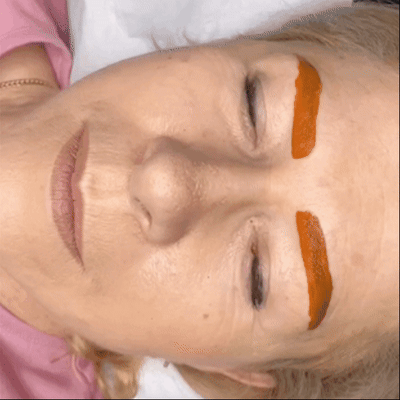motion of a client with a red pigment mask covering her eyebrows to warm the color motion of a client with a red pigment mask covering her eyebrows to warm the color